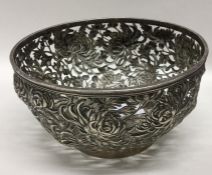 A Chinese silver bowl, the body decorated with flo