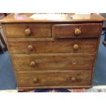 A pine chest of five drawers.