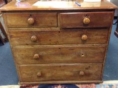 A pine chest of five drawers.