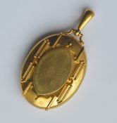 A large heavy high carat gold locket with loop top