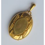 A large heavy high carat gold locket with loop top