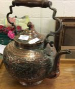 An embossed Oriental copper kettle with hinged top