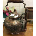 An embossed Oriental copper kettle with hinged top