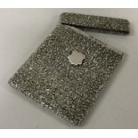 A good quality chased silver card case decorated w