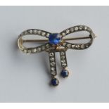 A large sapphire and rose diamond brooch in the fo