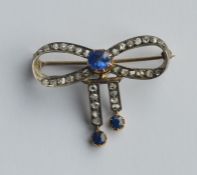 A large sapphire and rose diamond brooch in the fo