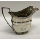 A Georgian silver cream jug with beaded rim. Londo