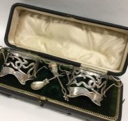 A pair of stylish silver salts complete with green