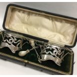 A pair of stylish silver salts complete with green