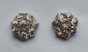 A pair of circular diamond cluster earrings in pla