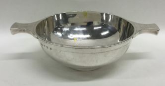 A heavy silver two handled quaich on pedestal