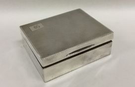 An engine turned silver cigarette box with hinged