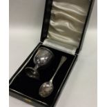 A boxed Edwardian silver egg cup and spoon. Approx.
