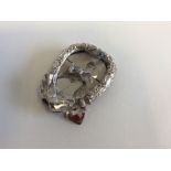 A small silver heart shaped picture frame with bow