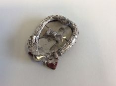 A small silver heart shaped picture frame with bow