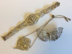 A collection of silver filigree jewellery containe