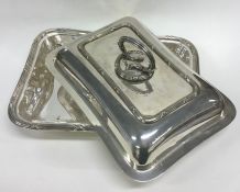 A silver plated entree dish.