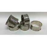 A group of five silver engine turned napkin rings.