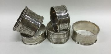 A group of five silver engine turned napkin rings.