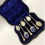 A boxed set of six silver ice cream spoons contain
