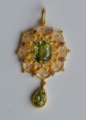 An Antique peridot and ruby circular pendant in cl