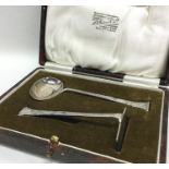 A cased silver pusher and spoon. Sheffield. Approx