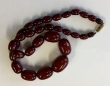 A graduated string of red amber beads with conceal