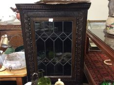 An oak lead glazed corner cabinet.