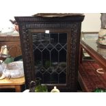 An oak lead glazed corner cabinet.