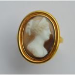 A good Antique hard stone cameo ring in gold band.