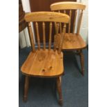 A pair of pine stick back chairs.