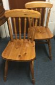 A pair of pine stick back chairs.