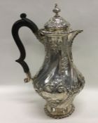 A good silver embossed water jug decorated with fl