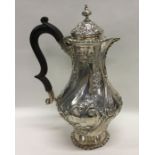 A good silver embossed water jug decorated with fl