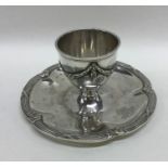 A Continental silver egg cup on stand with wavy rim