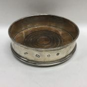 A silver wine coaster. London. By M&H. Approx. 113