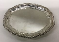 A silver circular waiter with gadroon rim. Approx.