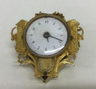 An Antique gilt fob watch decorated with flowers a