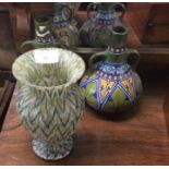 A pair of pottery vases together with one other.