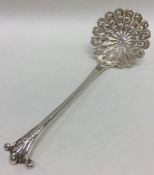 A good silver sifter spoon with scroll decoration.