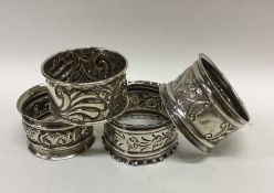 A group of four silver embossed napkin rings decor