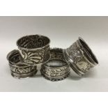 A group of four silver embossed napkin rings decor