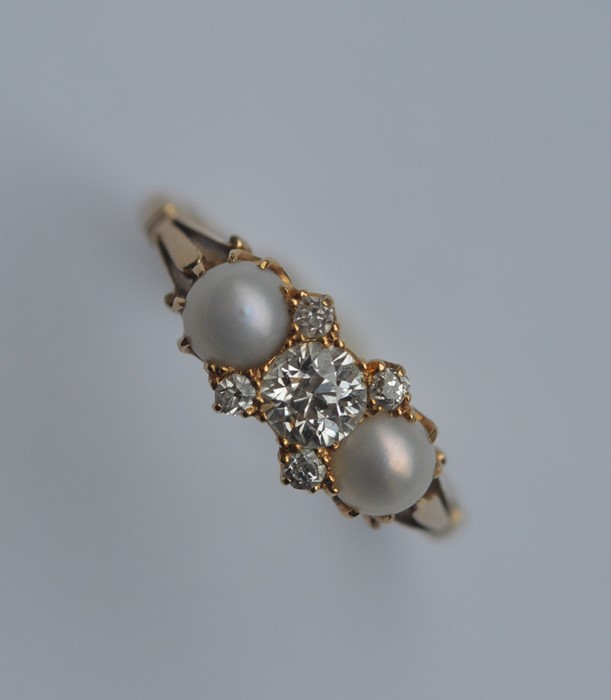 A pearl and diamond half hoop ring in 18 carat set