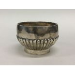 A small silver half fluted sugar bowl on pedestal