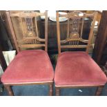 A pair of ivory inlaid dining chairs.