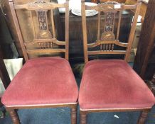 A pair of ivory inlaid dining chairs.