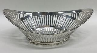 A silver boat shaped bonbon dish with ball decorat