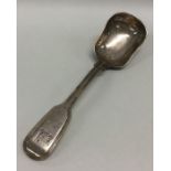 A heavy silver fiddle thread sugar scoop. London.