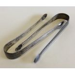 Two pairs of Georgian bright cut sugar tongs. Appr