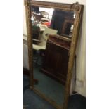 A large gilt framed mirror.